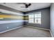 Bedroom with gray and yellow striped wall, ceiling fan and carpet at 23320 E Berry Ave, Aurora, CO 80016