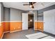 Bright bedroom with orange and gray walls, ceiling fan, and carpet at 23320 E Berry Ave, Aurora, CO 80016