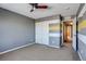 Bedroom with gray and yellow striped wall, ceiling fan and carpet at 23320 E Berry Ave, Aurora, CO 80016