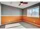 Bedroom with gray and orange walls, carpet, and window with natural light at 23320 E Berry Ave, Aurora, CO 80016