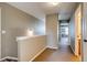 Upstairs hallway with carpet and access to bedrooms and bathroom at 23320 E Berry Ave, Aurora, CO 80016