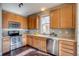 Modern kitchen with stainless steel appliances and wood cabinets at 23320 E Berry Ave, Aurora, CO 80016