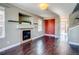 Living room with hardwood floors, fireplace, and access to the stairs at 23320 E Berry Ave, Aurora, CO 80016