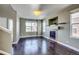 Bright living room with hardwood floors, fireplace, and large windows at 23320 E Berry Ave, Aurora, CO 80016