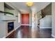 Living room with hardwood floors, fireplace, and access to the stairs at 23320 E Berry Ave, Aurora, CO 80016