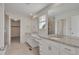 Bathroom with double sinks, granite counters, tile floor and glass enclosed shower at 640 Avena Dr, Elizabeth, CO 80107