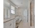 Bathroom with double sinks, granite counters, tile floor and glass enclosed shower at 640 Avena Dr, Elizabeth, CO 80107