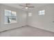 Bedroom featuring neutral carpet, ceiling fan and two windows for natural light at 640 Avena Dr, Elizabeth, CO 80107