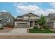 Charming two-story home featuring a well-kept lawn and a two-car garage at 640 Avena Dr, Elizabeth, CO 80107