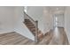 Bright entryway featuring wood floors and a staircase with iron railings at 640 Avena Dr, Elizabeth, CO 80107