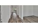 Modern hallway with light wood floors, white walls, and ample natural light at 640 Avena Dr, Elizabeth, CO 80107