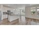 Well-lit kitchen featuring a center island, stainless steel appliances, and white cabinetry at 640 Avena Dr, Elizabeth, CO 80107