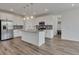 Modern kitchen with white cabinetry, stainless steel appliances, and granite countertops at 640 Avena Dr, Elizabeth, CO 80107