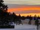 Peaceful outdoor scene featuring deer grazing in a snowy landscape under an colorful and dramatic sunset sky at 640 Avena Dr, Elizabeth, CO 80107