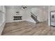 Open-concept living room with a modern fireplace, hardwood floors, and staircase access at 640 Avena Dr, Elizabeth, CO 80107