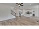 Spacious living room flowing into a kitchen with stainless steel appliances and an island at 640 Avena Dr, Elizabeth, CO 80107