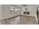 Bright living room featuring a modern fireplace, large windows, and beautiful hardwood floors at 640 Avena Dr, Elizabeth, CO 80107