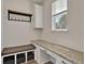 Functional mudroom with granite counters, storage, and bench seating by the window at 640 Avena Dr, Elizabeth, CO 80107