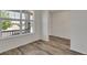 Bright room with wood floors, large windows, and fresh white walls at 640 Avena Dr, Elizabeth, CO 80107