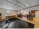 Finished basement with a wood-burning stove, leather couches, dining table and gym at 7585 Native Dancer Trl, Evergreen, CO 80439