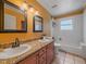Double sink bathroom with granite countertops and a separate toilet and bath area at 7585 Native Dancer Trl, Evergreen, CO 80439