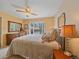Comfortable bedroom with large window view, ceiling fan, and wooden dresser at 7585 Native Dancer Trl, Evergreen, CO 80439