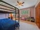 Bedroom with bunk beds, a window view, and wooden closet at 7585 Native Dancer Trl, Evergreen, CO 80439