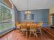 Dining room with hardwood floors, blue walls, and a large window overlooking trees and rock formations at 7585 Native Dancer Trl, Evergreen, CO 80439