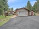 This property features an attached garage, convenient driveway, and a charming, neutral exterior at 7585 Native Dancer Trl, Evergreen, CO 80439