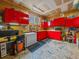 View of an organized garage space with red cabinetry and workbench at 7585 Native Dancer Trl, Evergreen, CO 80439
