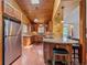 Spacious kitchen with stainless steel appliances, wood ceiling, and granite counters at 7585 Native Dancer Trl, Evergreen, CO 80439