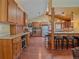Bright and open kitchen with wood cabinets, stainless steel appliances, and breakfast bar seating at 7585 Native Dancer Trl, Evergreen, CO 80439