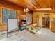 Playroom with lots of storage, wood ceiling, whiteboard, and a colorful rug at 7585 Native Dancer Trl, Evergreen, CO 80439