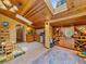 Playroom with lots of storage, wood ceiling, sink, skylight, and a colorful rug at 7585 Native Dancer Trl, Evergreen, CO 80439