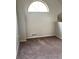 Neutral bedroom featuring an arched window letting in natural light and plush carpeting at 4923 S Carson St # 210, Aurora, CO 80015