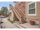 Close up of townhouse showing stairway and entrance, brick and wood siding at 4923 S Carson St # 210, Aurora, CO 80015