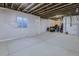 Spacious unfinished basement with a window, exposed ceiling and wrapped walls at 10992 Xanadu St, Commerce City, CO 80022