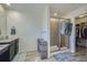Bright bathroom with a glass-enclosed shower and modern design elements at 10992 Xanadu St, Commerce City, CO 80022
