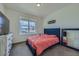 Cozy bedroom features a plush blue bed, soft carpet, and a bright window at 10992 Xanadu St, Commerce City, CO 80022