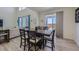 Bright dining area features wood floors, a large table, and natural light from the sliding glass door at 10992 Xanadu St, Commerce City, CO 80022