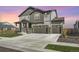 Charming two-story home featuring a large driveway and attractive gray siding at 10992 Xanadu St, Commerce City, CO 80022
