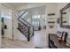 Bright foyer featuring a staircase, hardwood floors, and an open view of the living spaces at 10992 Xanadu St, Commerce City, CO 80022