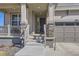 Close-up of the welcoming front porch with stone pillars and steps leading to the entrance at 10992 Xanadu St, Commerce City, CO 80022