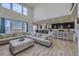 Bright living room with a large sectional sofa, open to the kitchen and dining area at 10992 Xanadu St, Commerce City, CO 80022