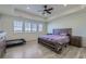 Bright bedroom featuring wood-look flooring, a ceiling fan, and large windows at 10992 Xanadu St, Commerce City, CO 80022