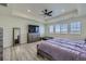 Large bedroom with wood-look floors, ceiling fan, and a comfortable dog bed at 10992 Xanadu St, Commerce City, CO 80022