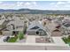A high angle of a suburban single Gathering home with a manicured front yard and mountain views in the distance at 762 Tailings Dr, Monument, CO 80132