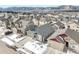 This aerial shows a residential neighborhood nestled against snow-capped mountains with easy access to urban amenities at 762 Tailings Dr, Monument, CO 80132