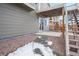 A cozy backyard area features a small concrete patio and the base of an elevated deck with stairs at 762 Tailings Dr, Monument, CO 80132