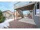 A cozy backyard with a patio, green foliage, and an elevated deck with stairs at 762 Tailings Dr, Monument, CO 80132